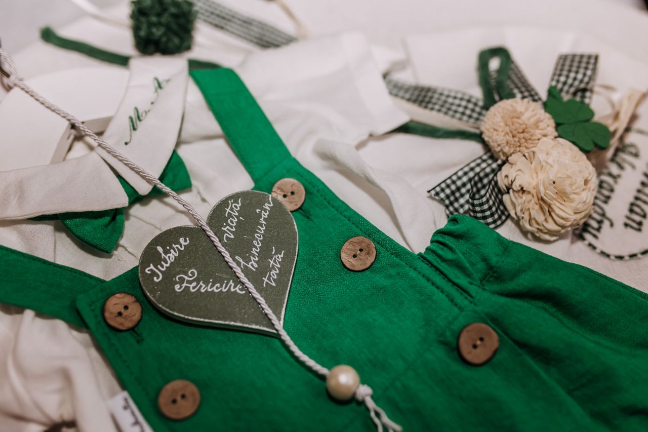 Services Charming children's clothing featuring green details, buttons, and a heart accent for a rustic look.