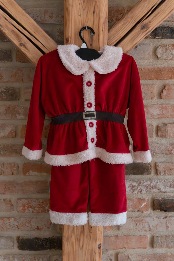 Services Adorable red Santa Claus costume for kids, perfect for holiday celebrations.